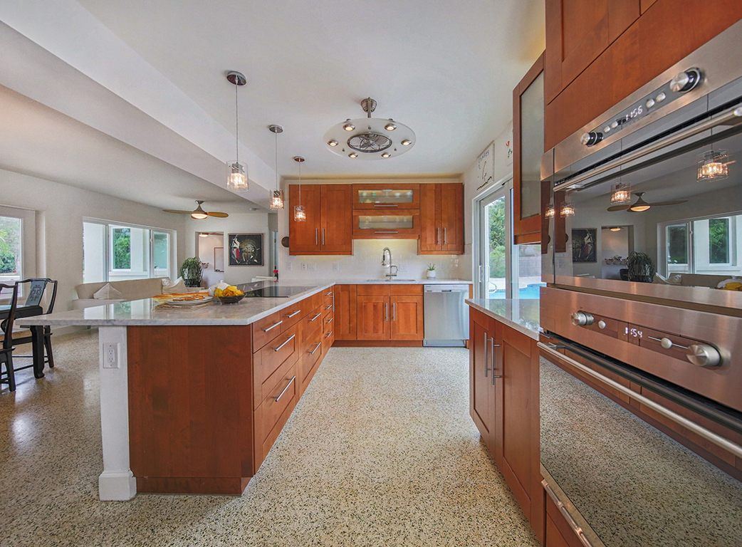 Kitchen with wall ovens and a long island