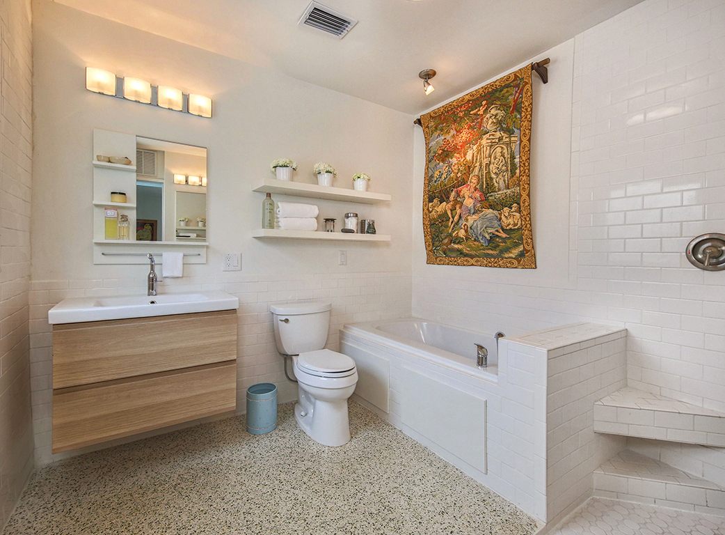 Bathroom with a tub and floating vanity