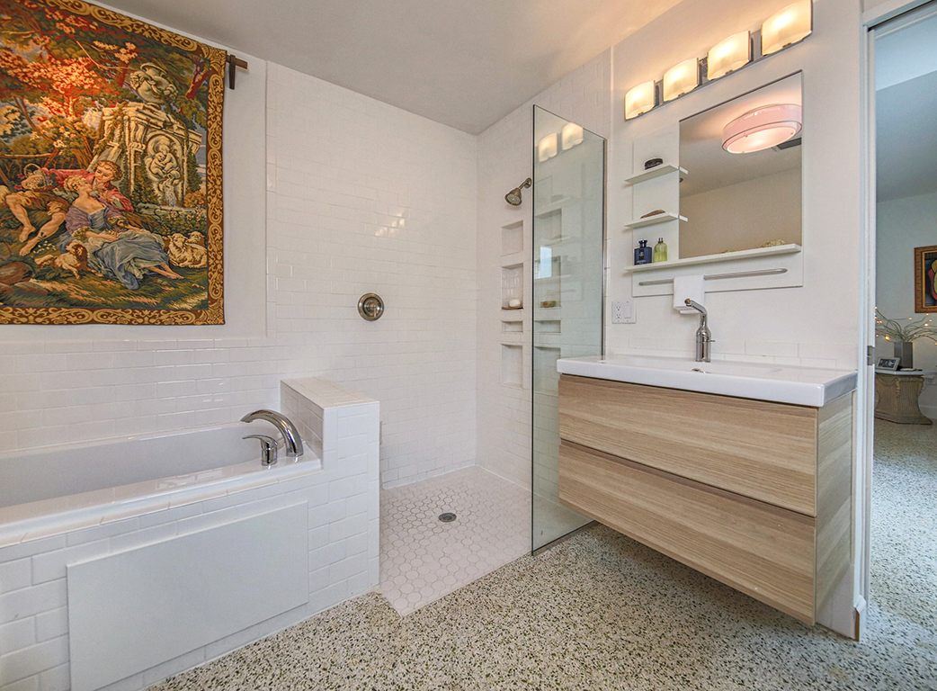 Bathroom with a soaking tub and tapestry