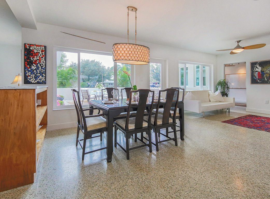 Dining room with a drum pendant and terrazzo floor